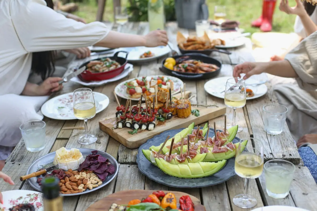 An outdoor table full of sharing plates and drinks